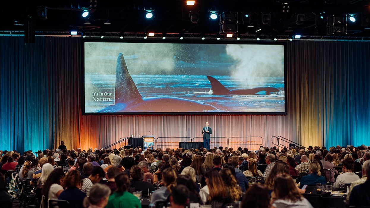 AZA Annual Conference with a keynote speaker on stage; screen shows "It's In Our Nature" with orcas.