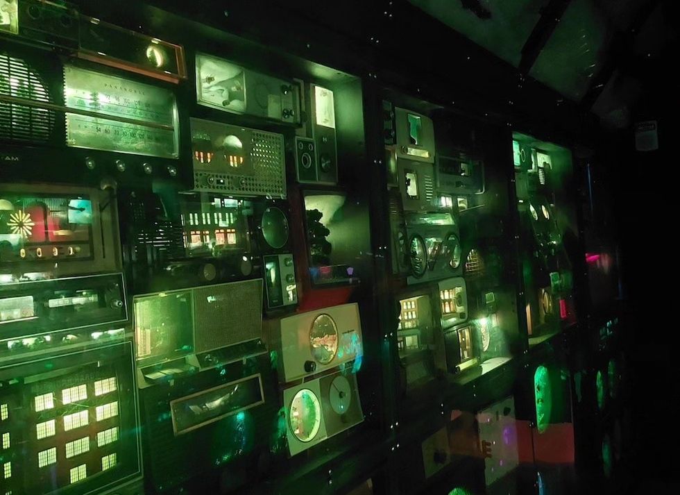 Bank of screens at Meow Wolf Convergence Session