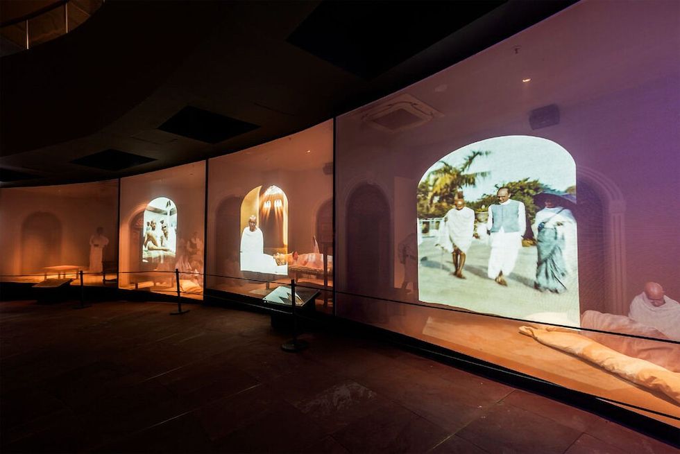 Bapu Tower Museum exhibit with projected historical images on large curved screens.