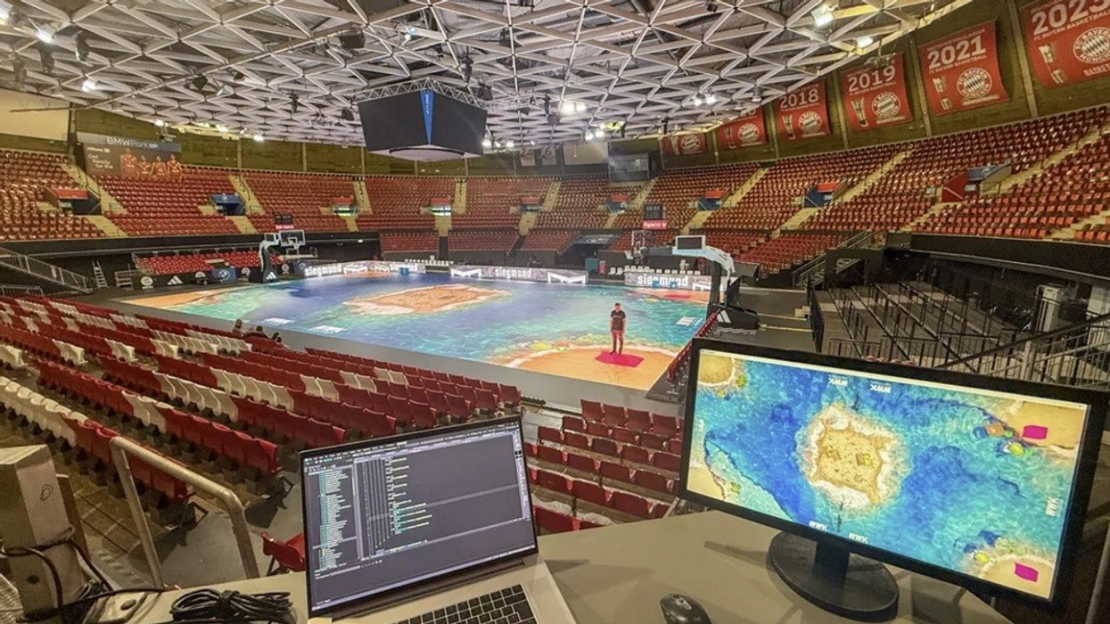 Basketball court with LED floor and monitor setup in empty arena.