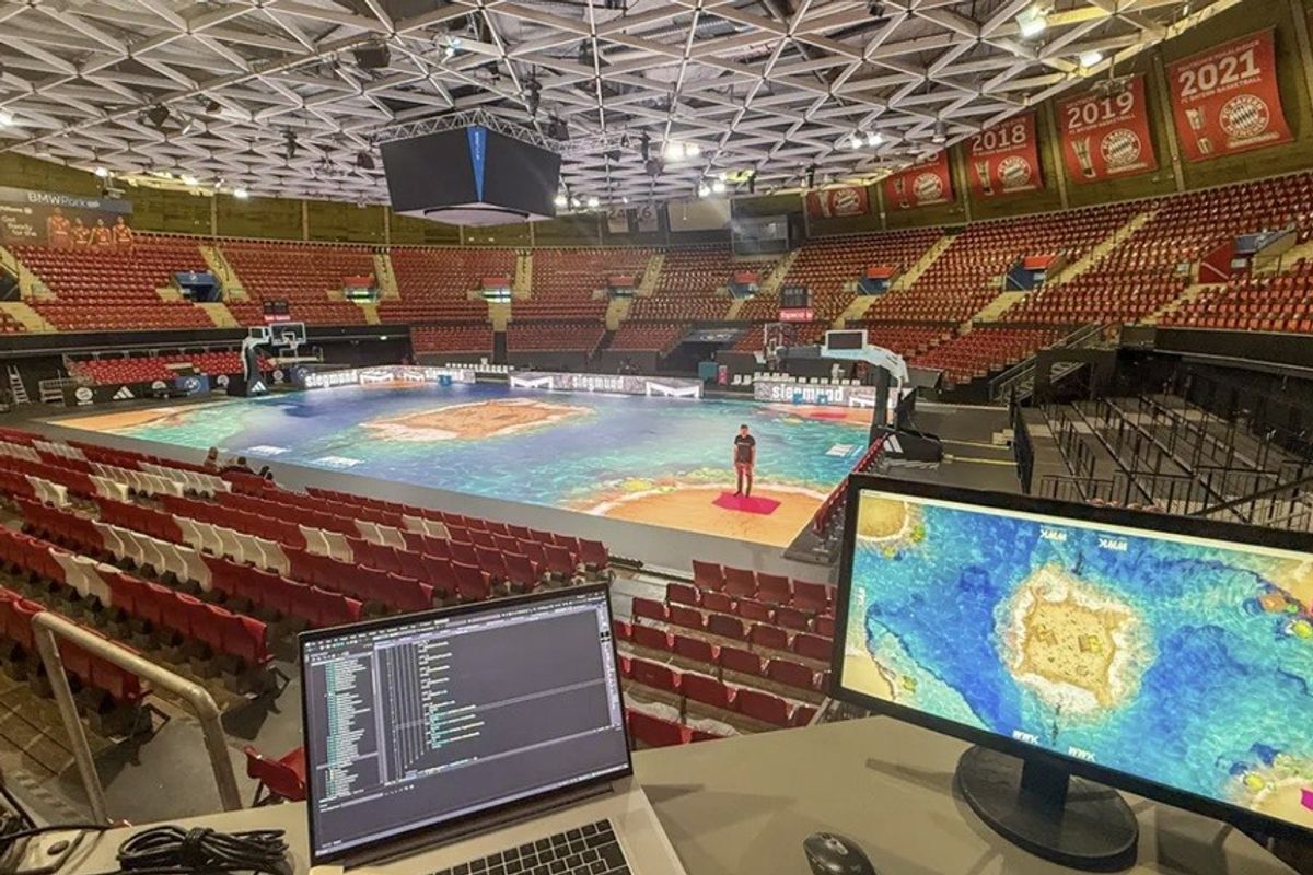 Basketball court with virtual map projection and monitor setup in empty arena.