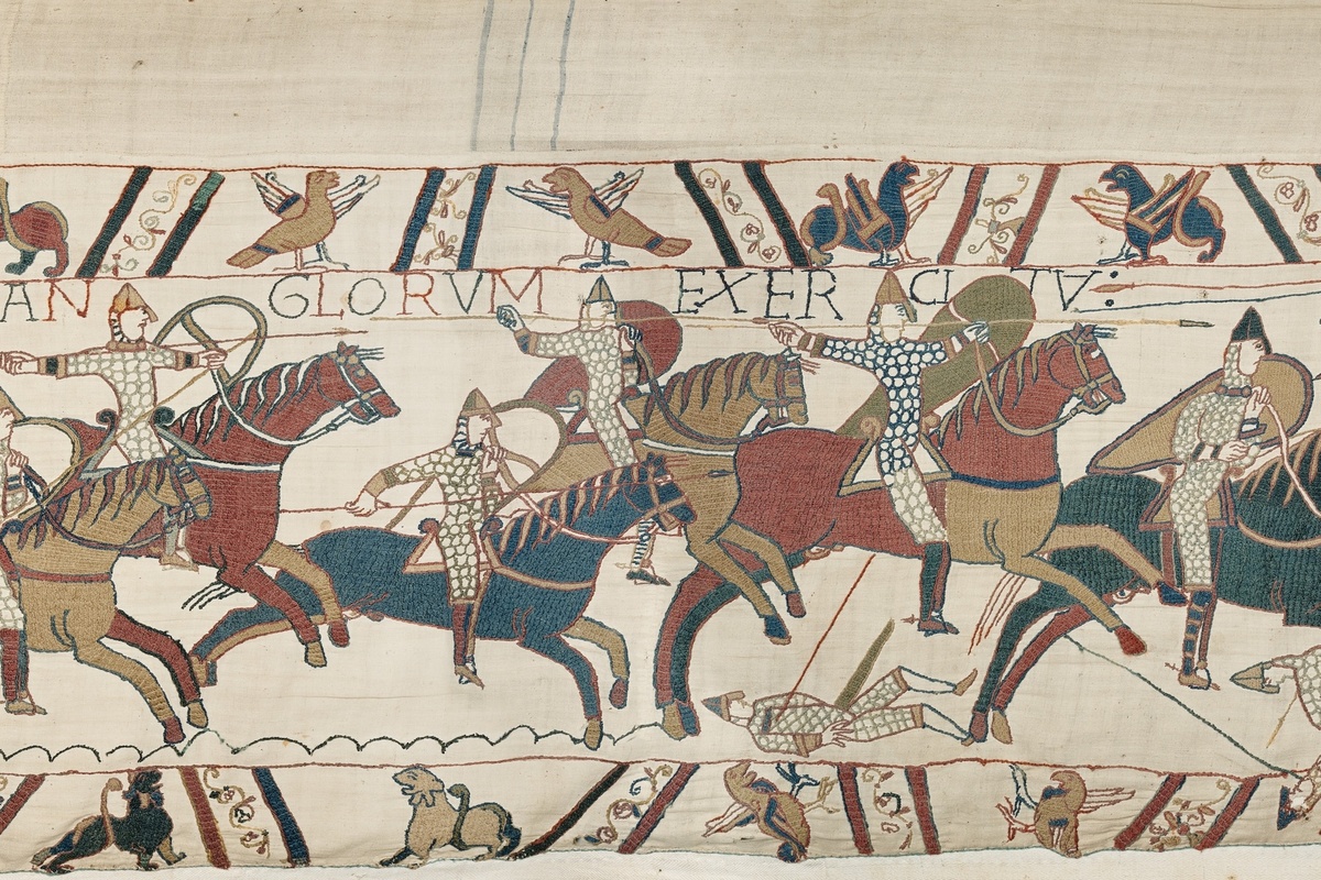 Bayeux Tapestry depicting knights on horseback in a battle scene.