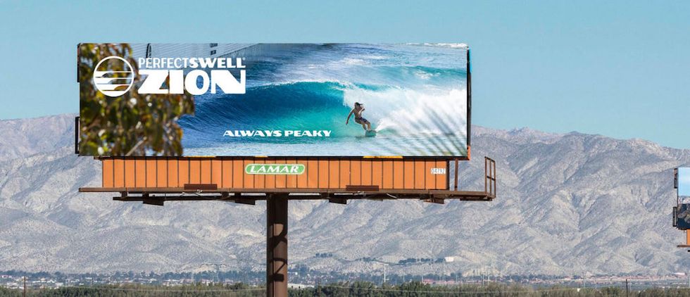 Billboard of a surfer riding a wave, with text "PERFECTSWELL ZION, ALWAYS PEAKY."