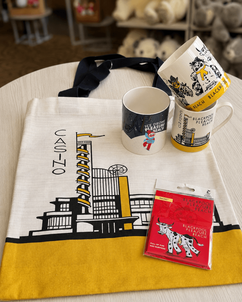 Blackpool tote bag, three mugs, and a magnet on a table.