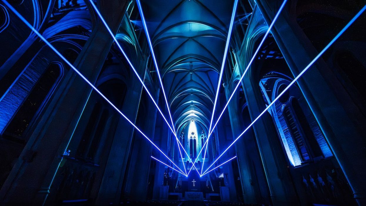 Blue laser beams illuminate Grace Cathedral's arched ceiling and nave during AURA