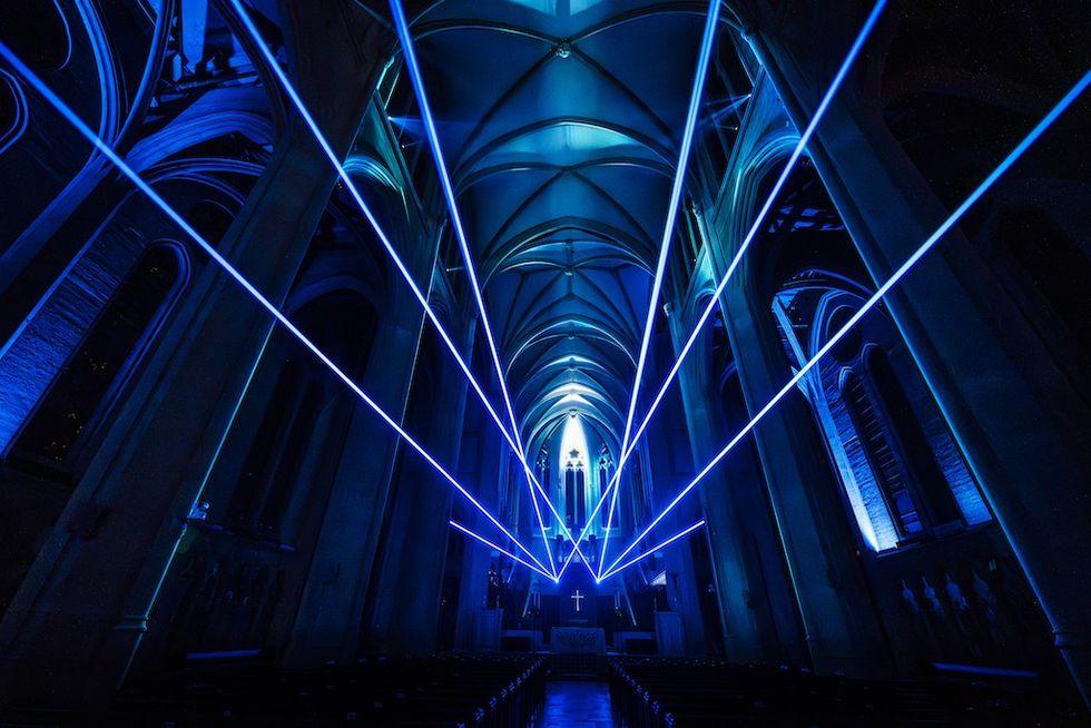 Blue laser beams illuminate Grace Cathedral's arched ceiling and nave during AURA