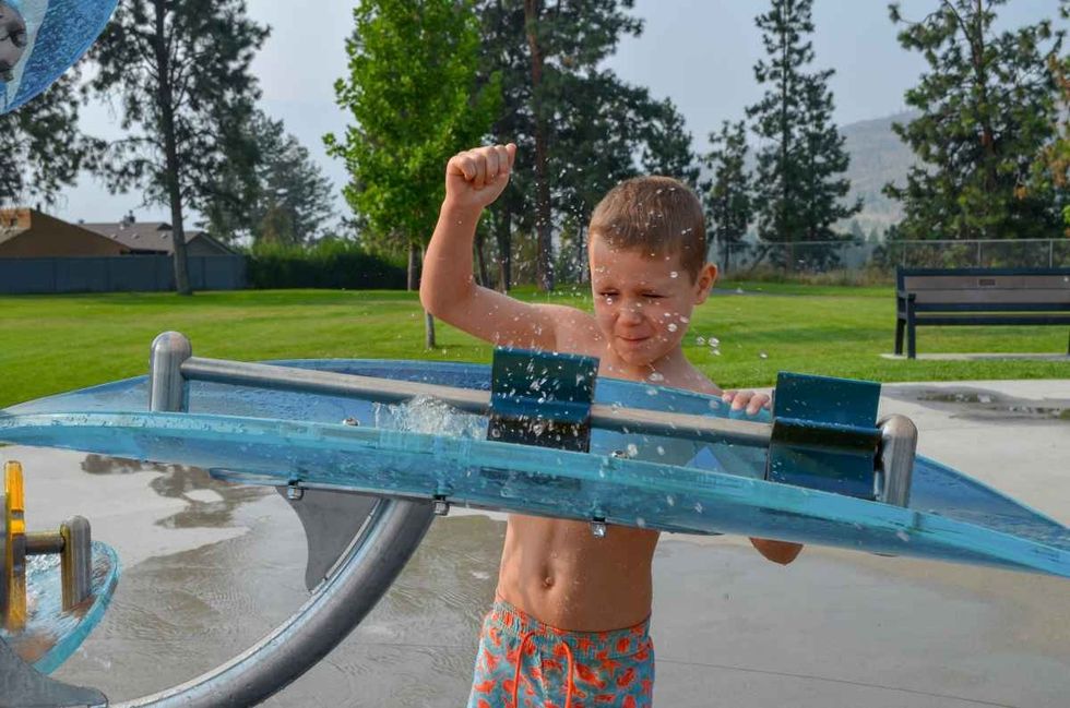 boy plays with waterways elements by waterplay solutions