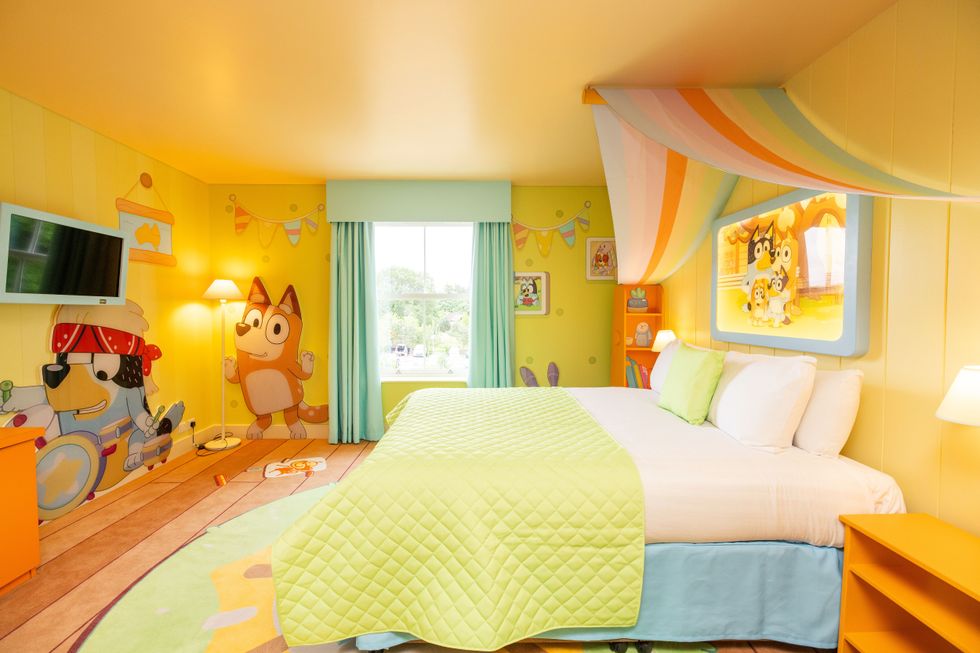 Bright room with Bluey cartoon decor, featuring a cozy bed and colorful wall mural.