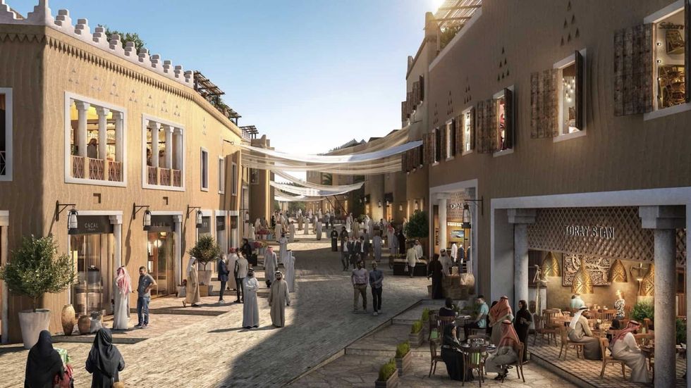 Bustling Middle Eastern street with shops, cafes, and people mingling under shade cloths at Diriyah