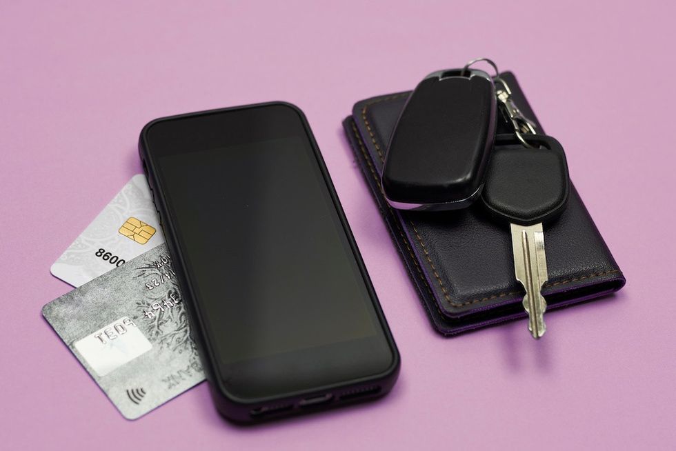 Car keys, mobile phone and credit cards on blue theme park lockers