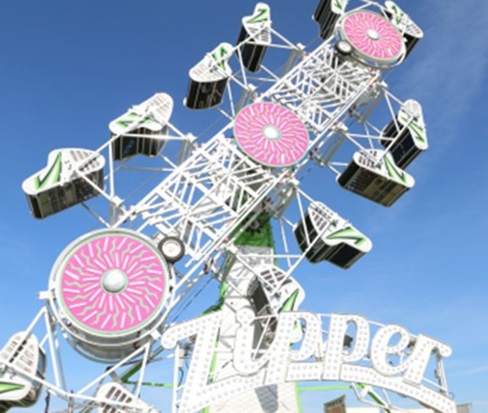 Carnival ride "Zipper" with colorful design against a clear blue sky.