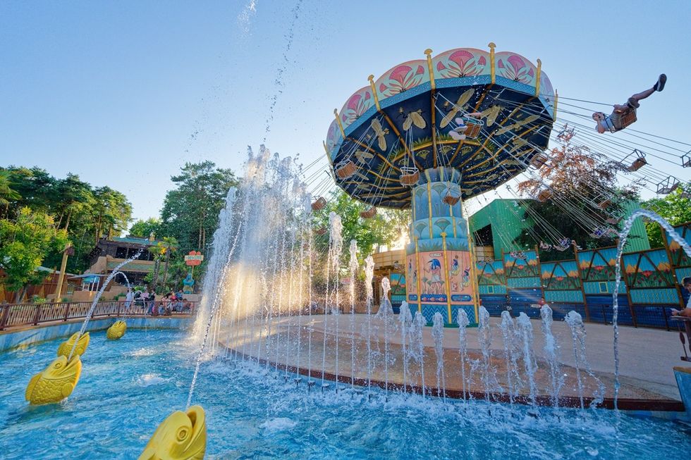 Carousel swing ride with fountains and gold fish sculptures at Parc Ast\u00e9rix