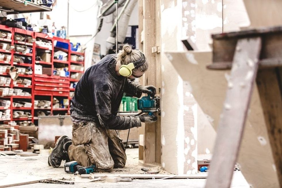 carpenter in workshop at tema design by mk illumination