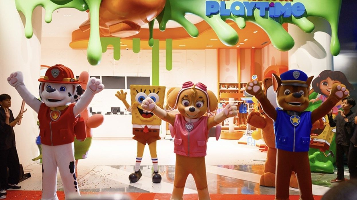 Cartoon mascots at a Nickelodeon Playtime entrance with green slime decor.
