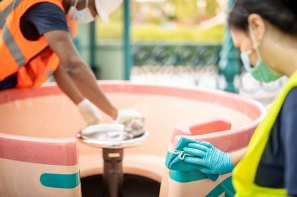 Cast members cleaning teacups ride at Disneyland Paris Guest experience COVID 19