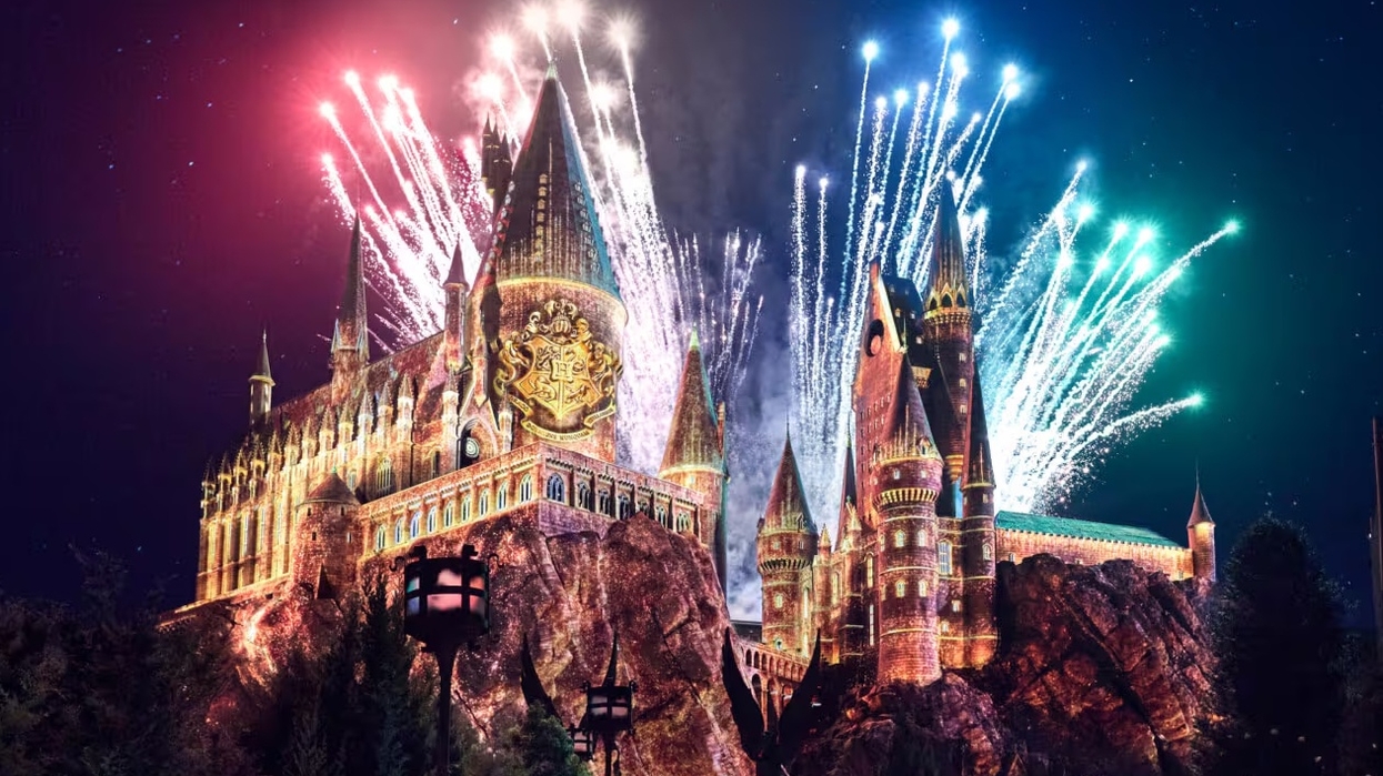 Castle at Universal Orlando Resort with fireworks lighting up the night sky behind it.