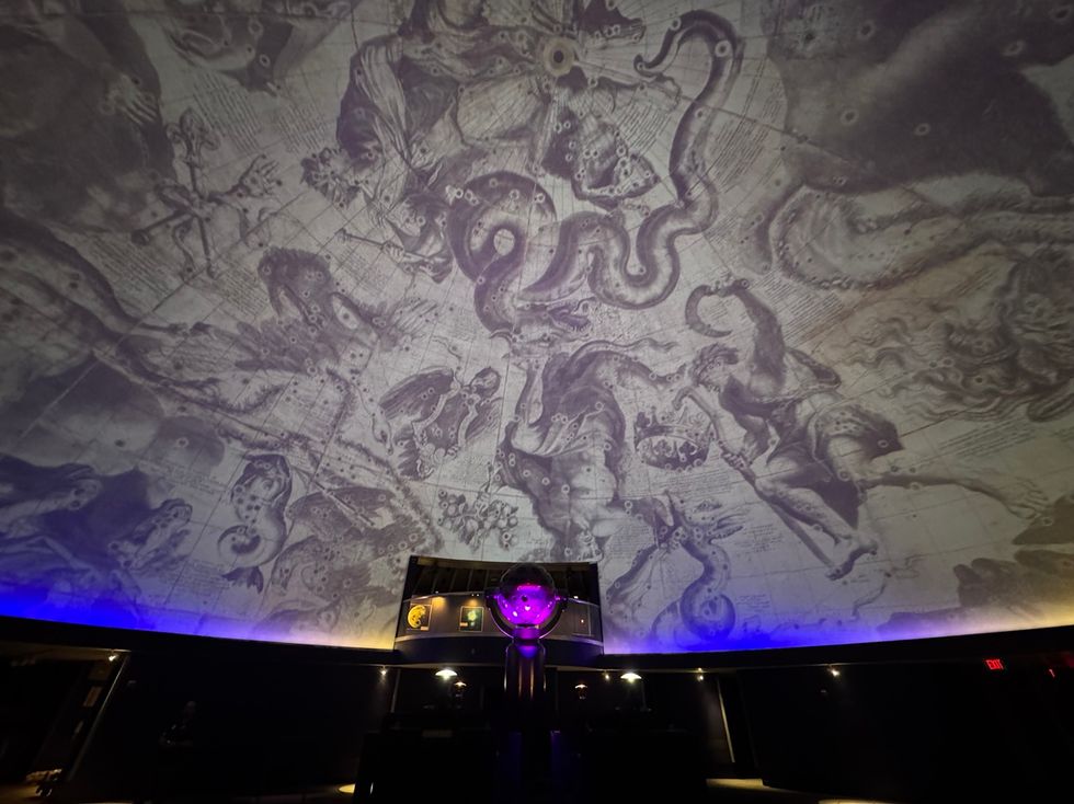 Ceiling with intricate constellation artwork in a dimly lit planetarium dome at the James S. McDonnell Planetarium
