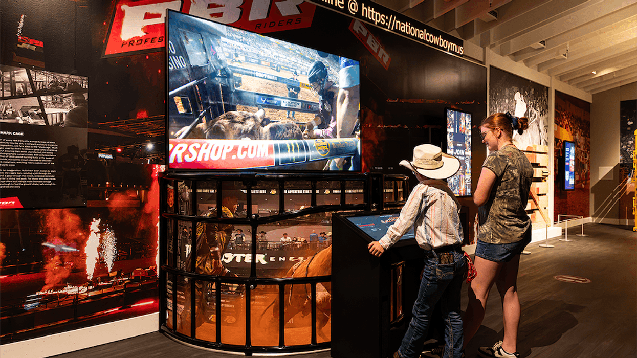 Child and adult viewing rodeo exhibit at National Cowboy Museum.