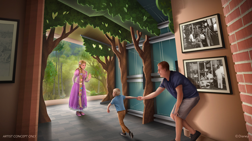 Child meeting a princess in a forest-themed room, guided by an adult.