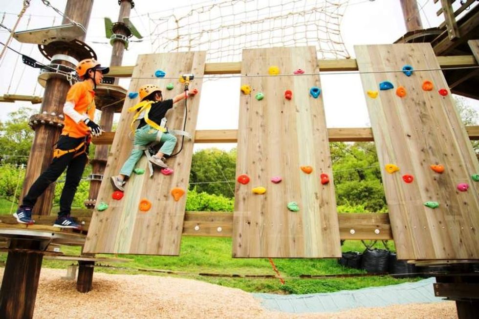 child on climbing wall at harvest hill osaka japan