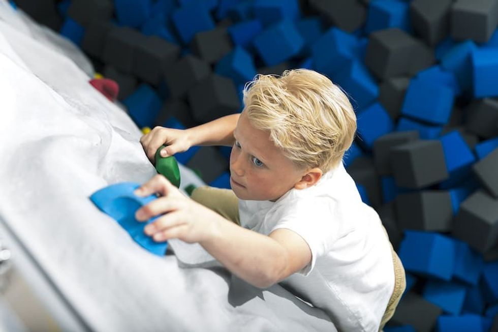 Child on climbing wall FECs COVID 19