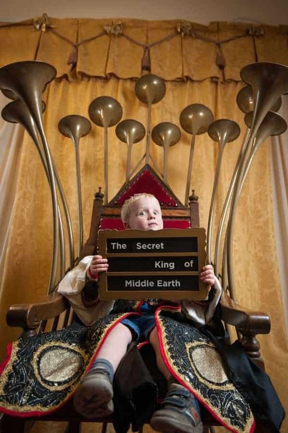 Child sitting on The Talking Throne at The Story Museum