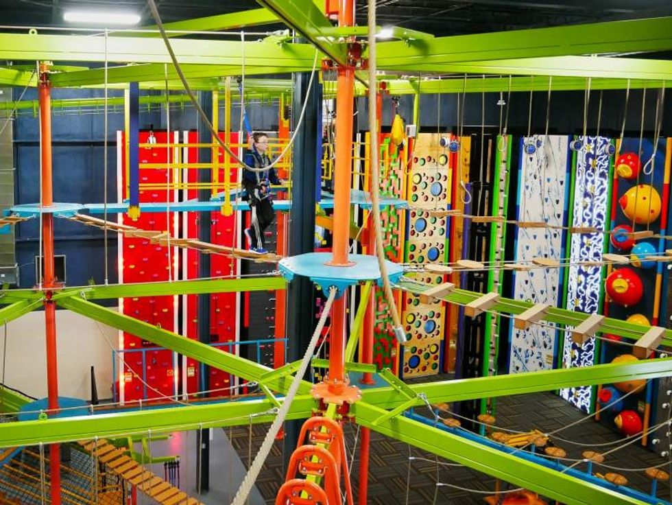 child tries out new single redundant slingline on an RCI ropes course