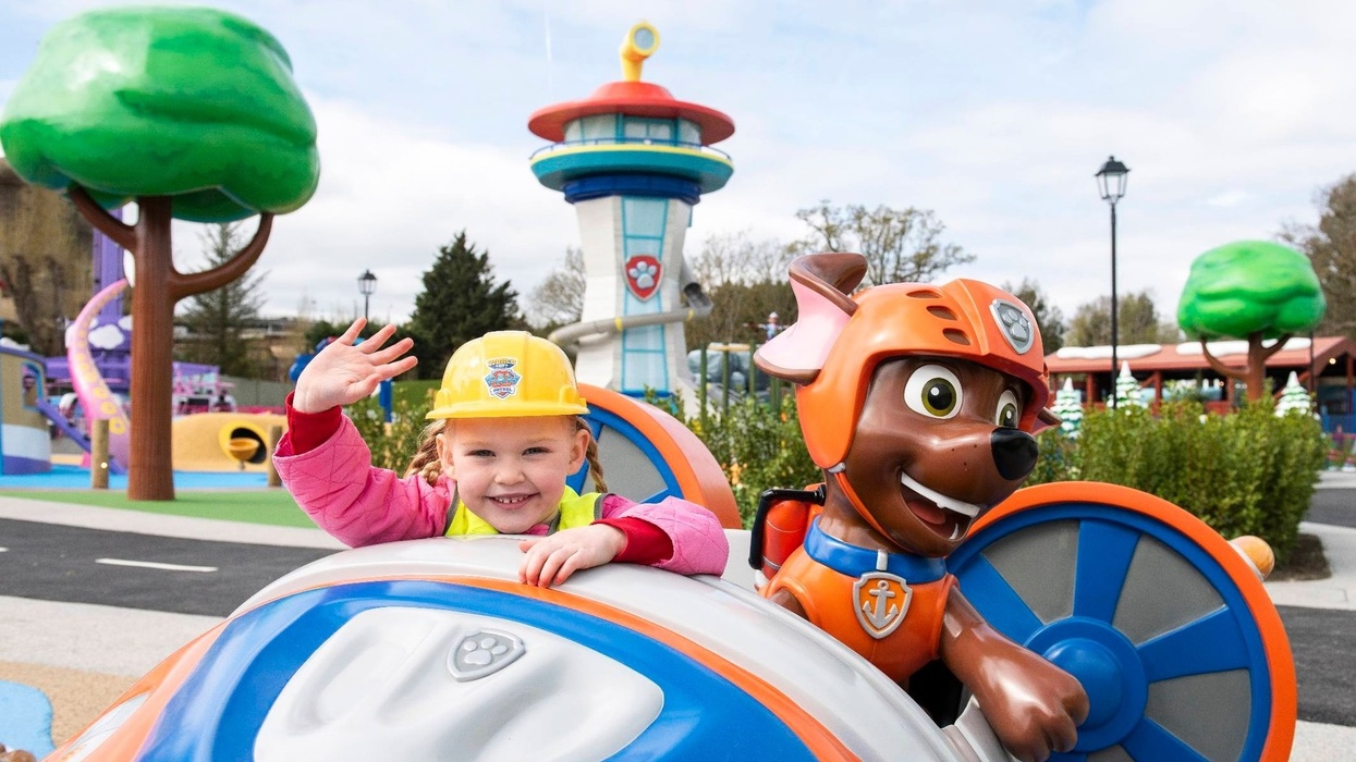 Child waving beside Paw Patrol character at Chessington World of Adventures Resort
