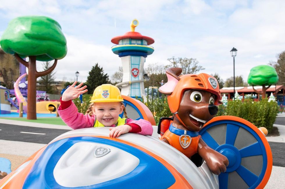 Child waving beside Paw Patrol character at Chessington World of Adventures Resort