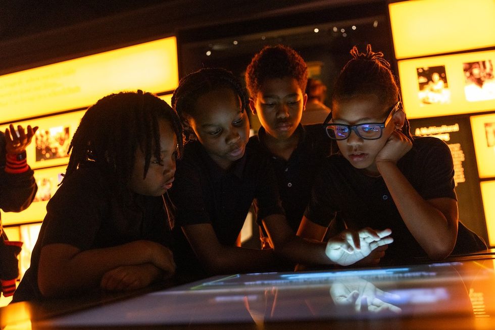 Children engaged with a touchscreen display at Obama Presidential Center Museum