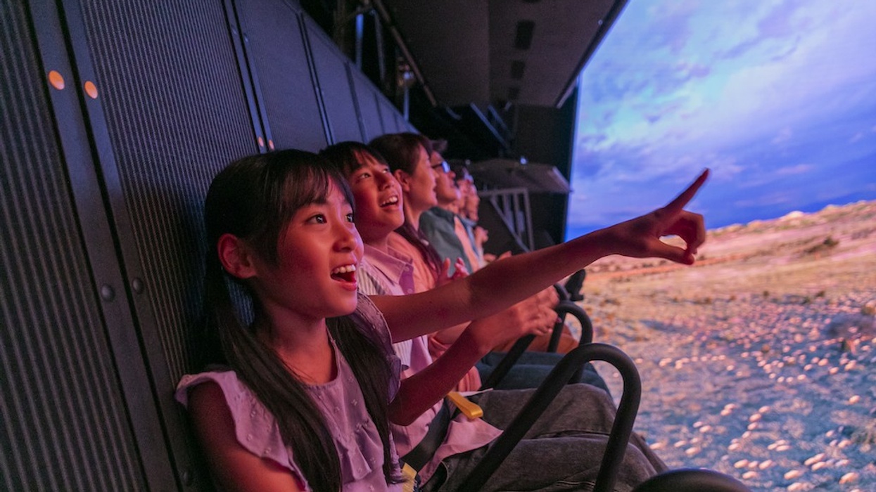Children excitedly enjoying a simulated experience with vibrant visuals.