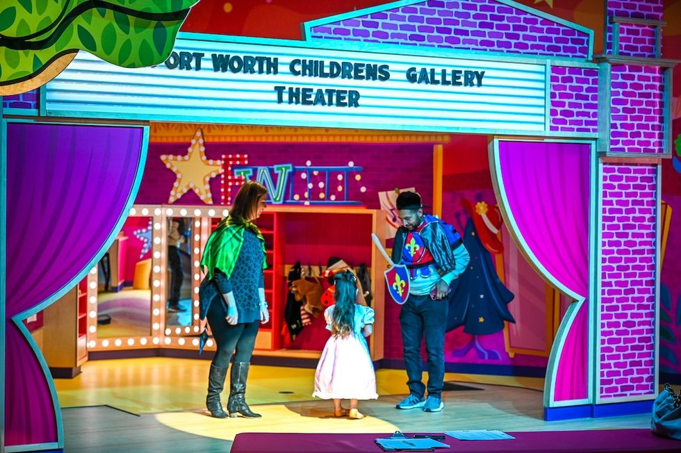Children in colorful costumes on a vibrant stage set at Fort Worth Museum of Science and History