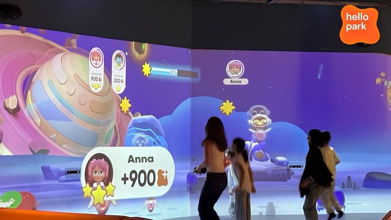 Children interacting with a space-themed digital game at Hello Park.