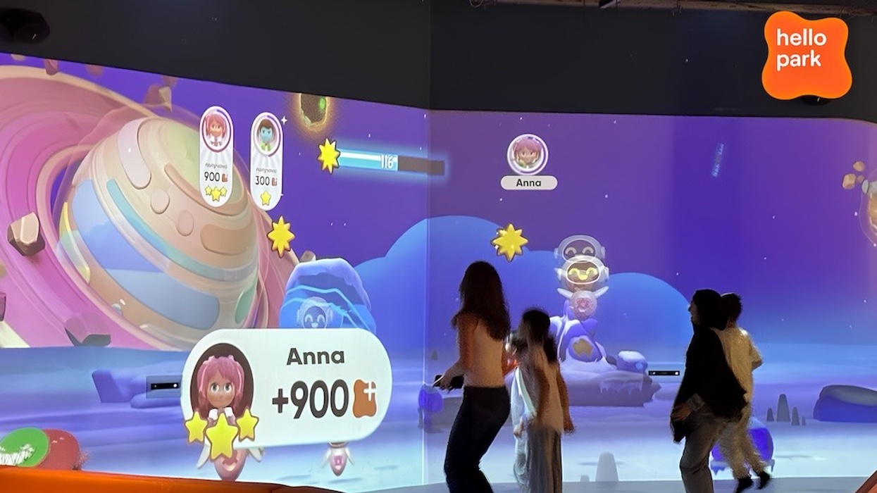 Children interacting with a space-themed digital game at Hello Park.