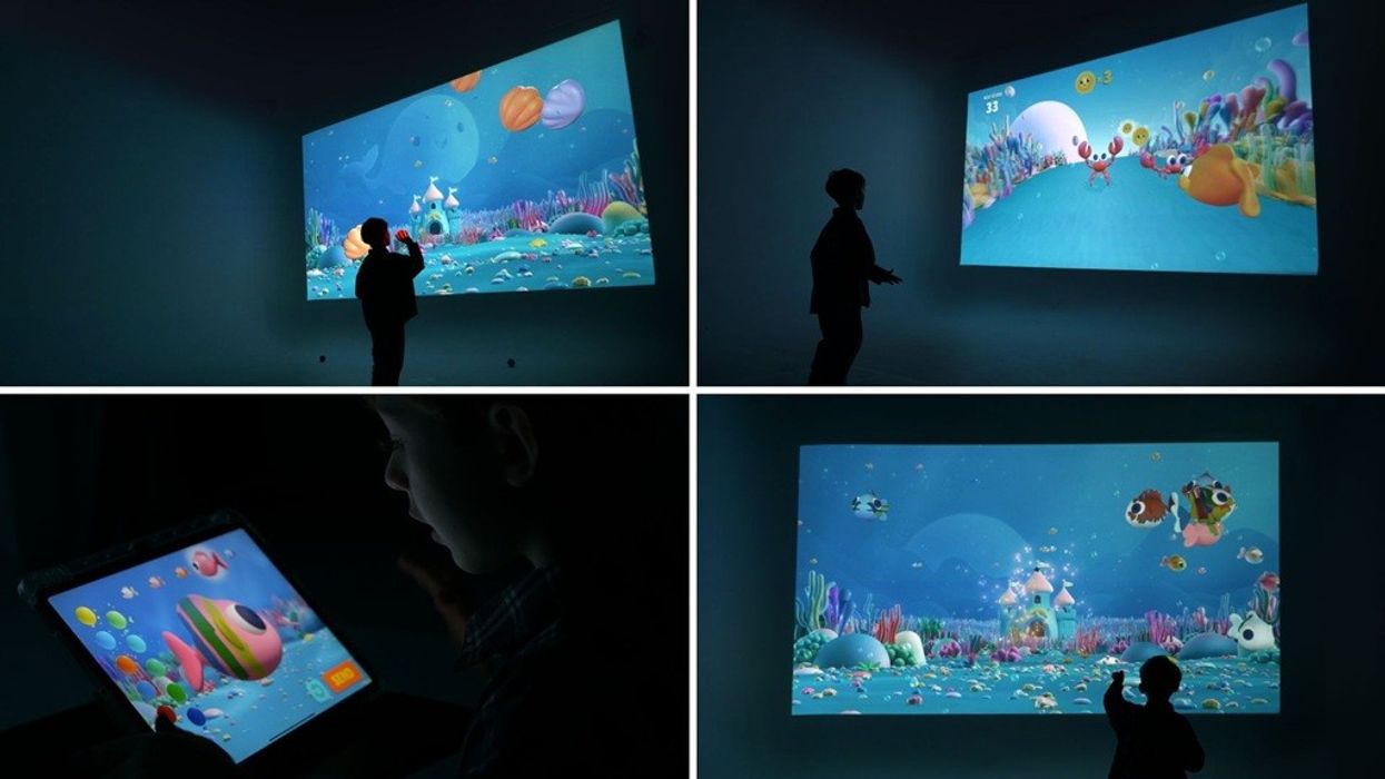 Children interacting with colorful underwater scenes on screens and a tablet.