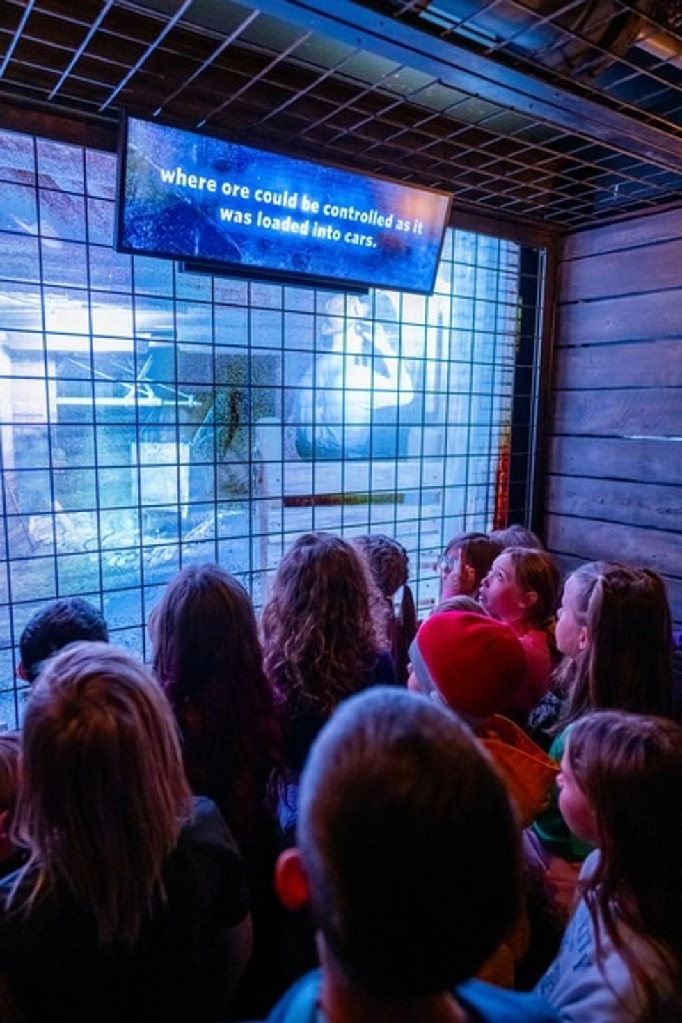Children observing a mining exhibit with educational text display at Montana Heritage Center.