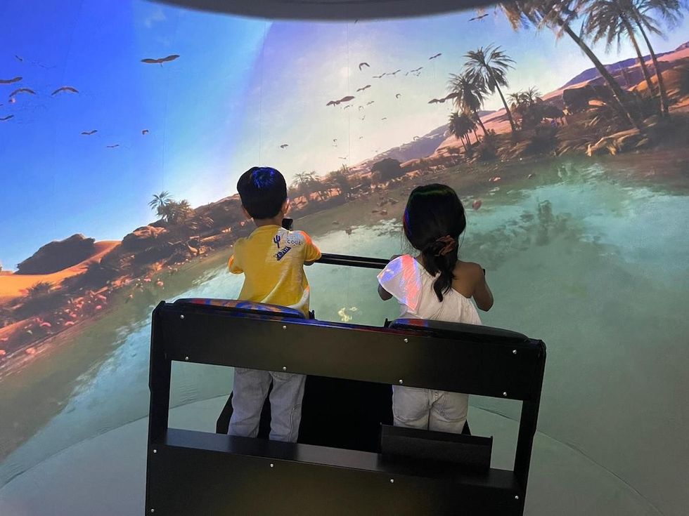 Children on the Super Reality Stand-Up Theater by Full Dome Pro, at IAAPA Asia 2023.
