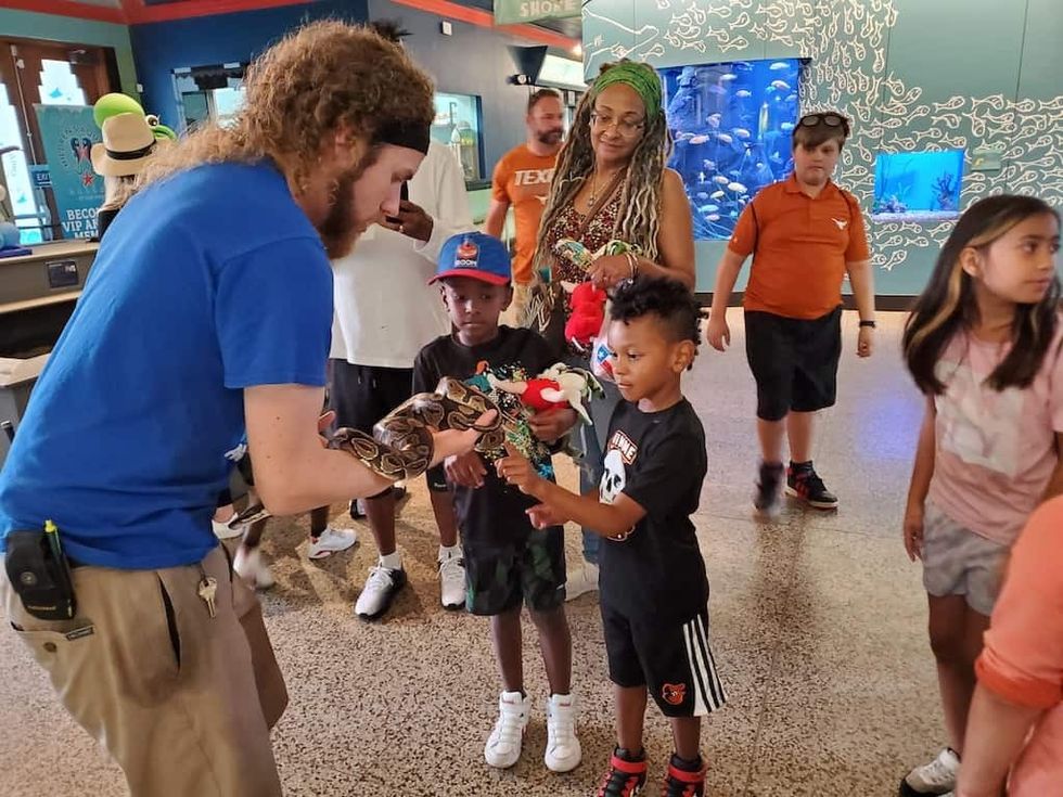 Children's Aquarium Dallas - young visitors get hands on with snake