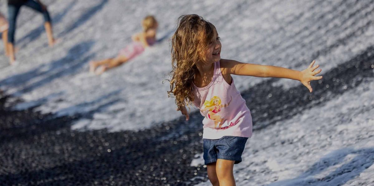 Children visit Surreal, the water feature