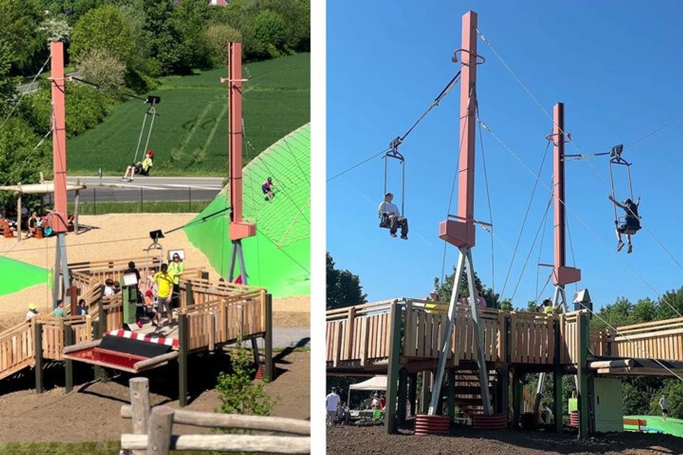 Children ziplining from tall platforms in an adventure park setting.