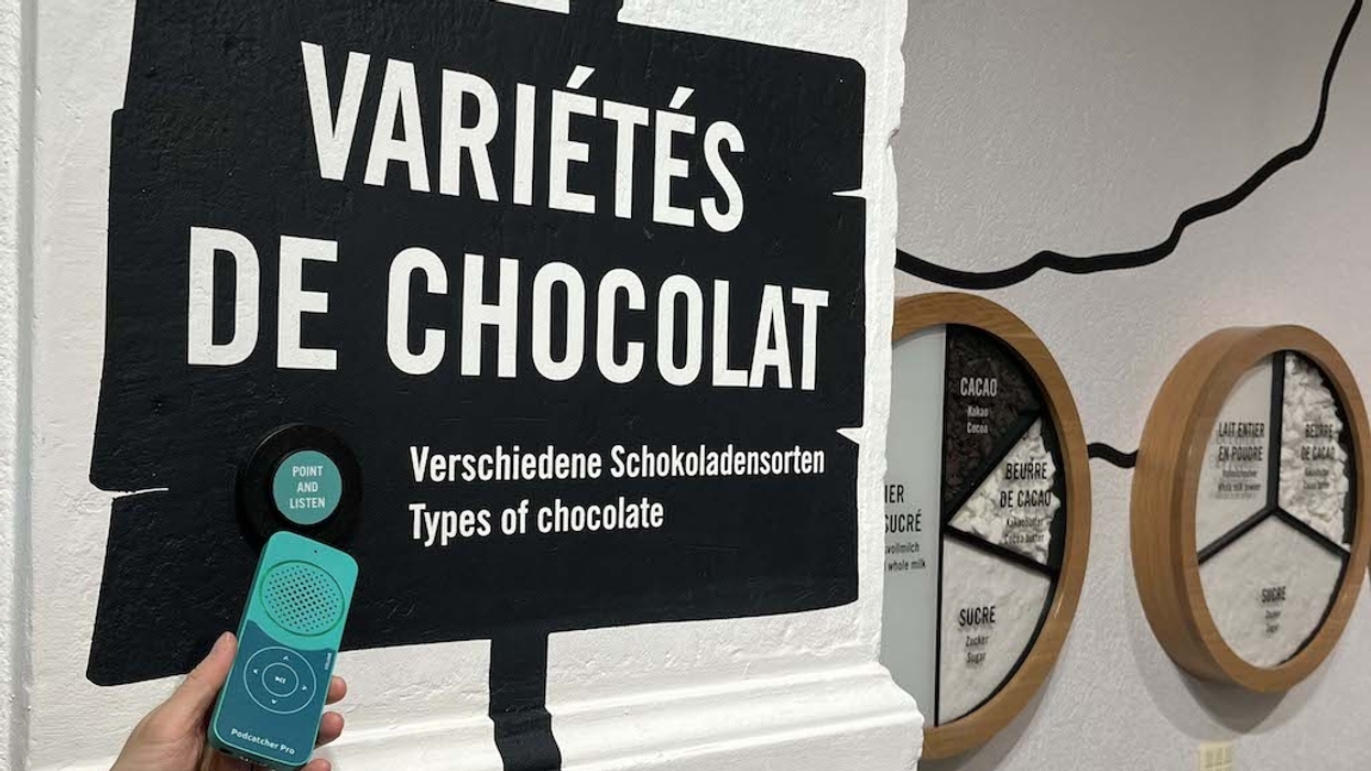 Chocolate varieties sign with a Guide-ID audio guide in a museum exhibit at Maison Cailler