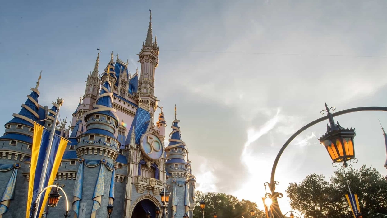 Cinderella Castle adorned for a 50th anniversary celebration at sunset at Magic Kingdom