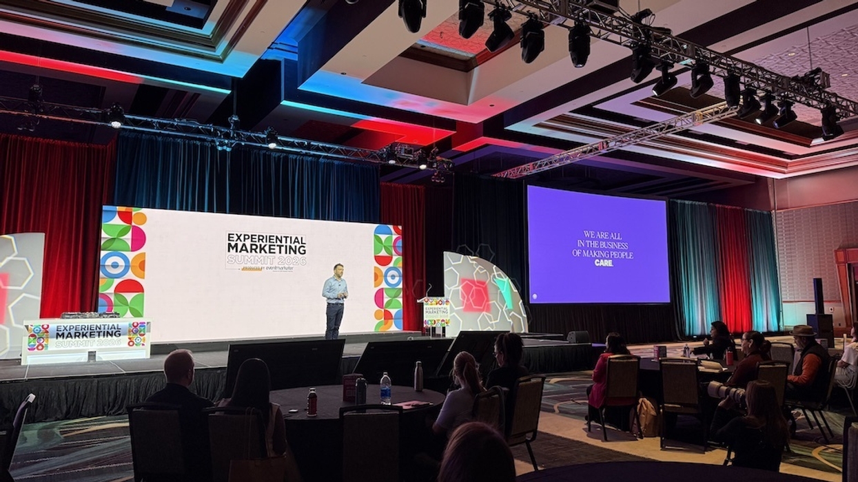 Cirque du Soliel's Florent Bayle-Labouré on stage at Experiential Marketing Summit 2023 with audience seated.