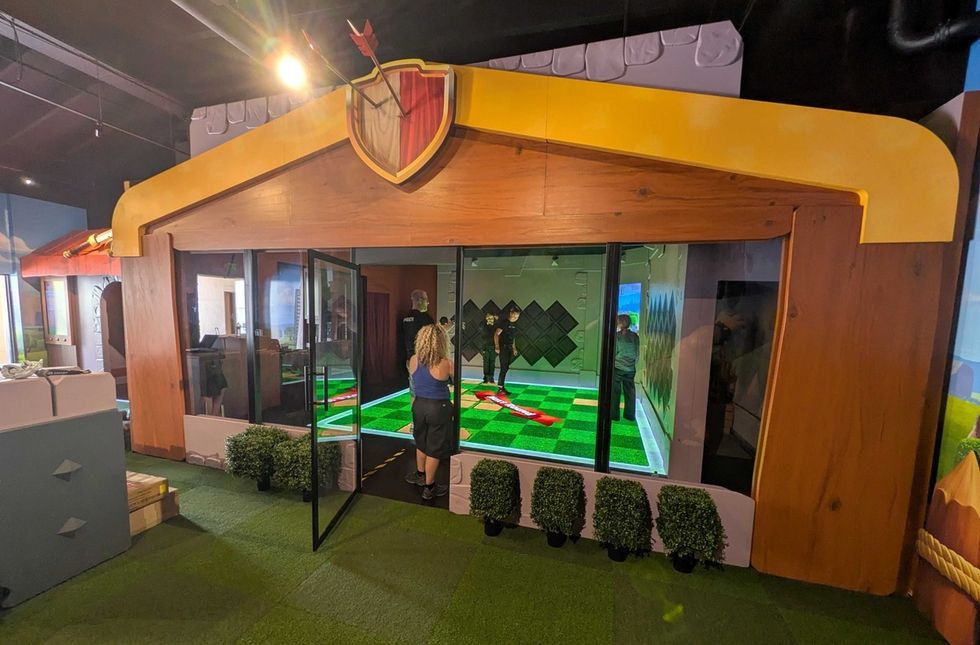 Clash for the Stache setup inside a themed indoor area with shield decoration on top.
