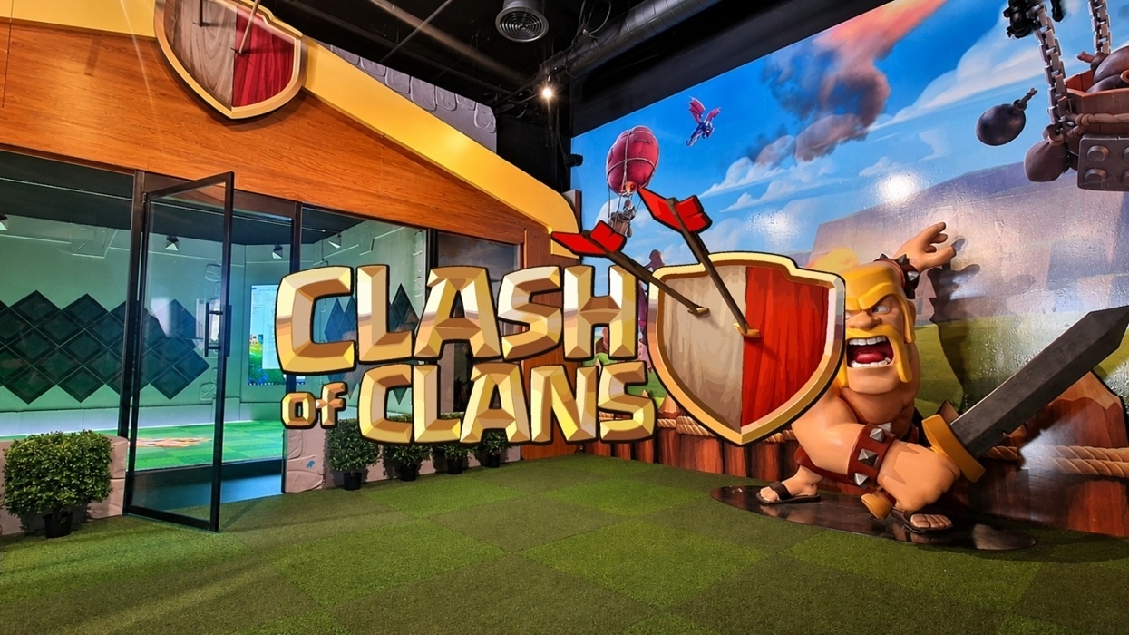 Clash of Clans-themed room with large logo and character mural on the wall.