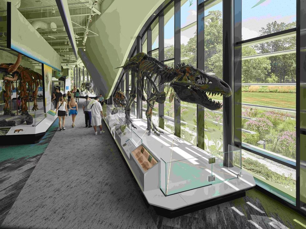 Cleveland Museum of Natural History exhibit with dinosaur skeletons and visitors walking through.