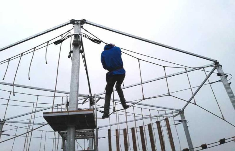 climber tests skills on kanopeo's SUMAA mobile aerial adventure trailer