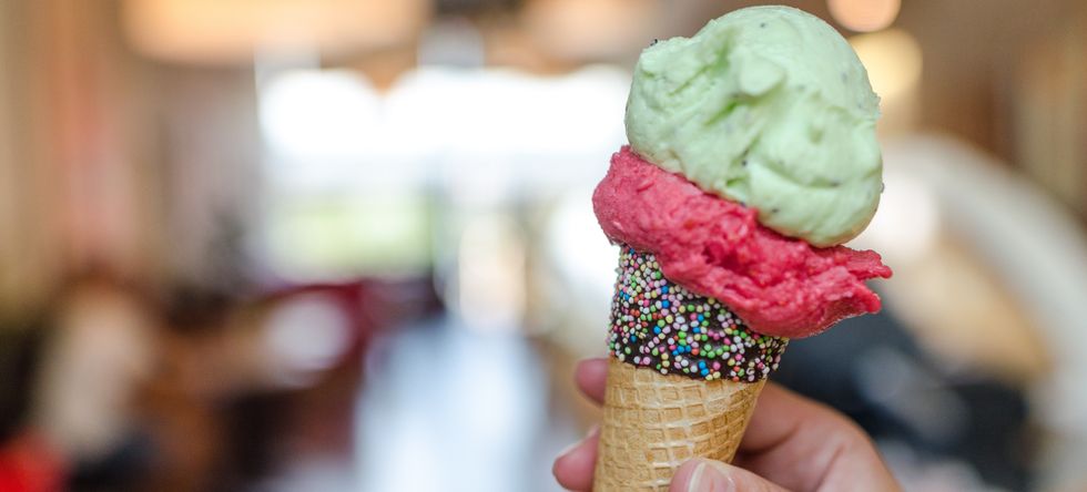 close up photo of person holding assorted flavor ice cream 1352245