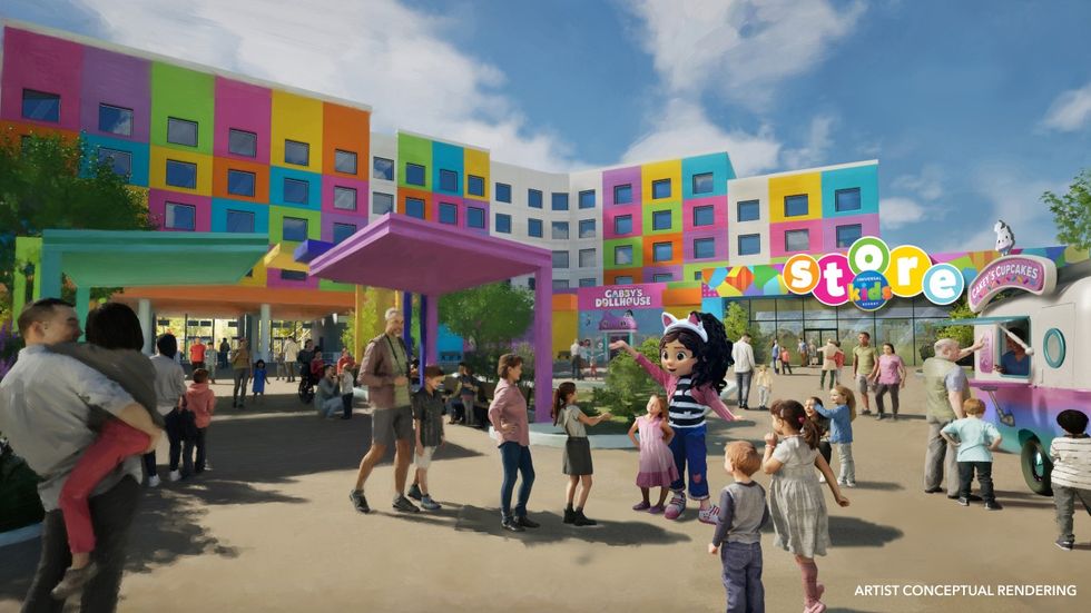 Colorful building facade with people and children in a lively outdoor plaza.