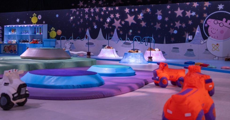 Colorful children's play area with space theme and toy vehicles at Peppa Pig Space Adventure